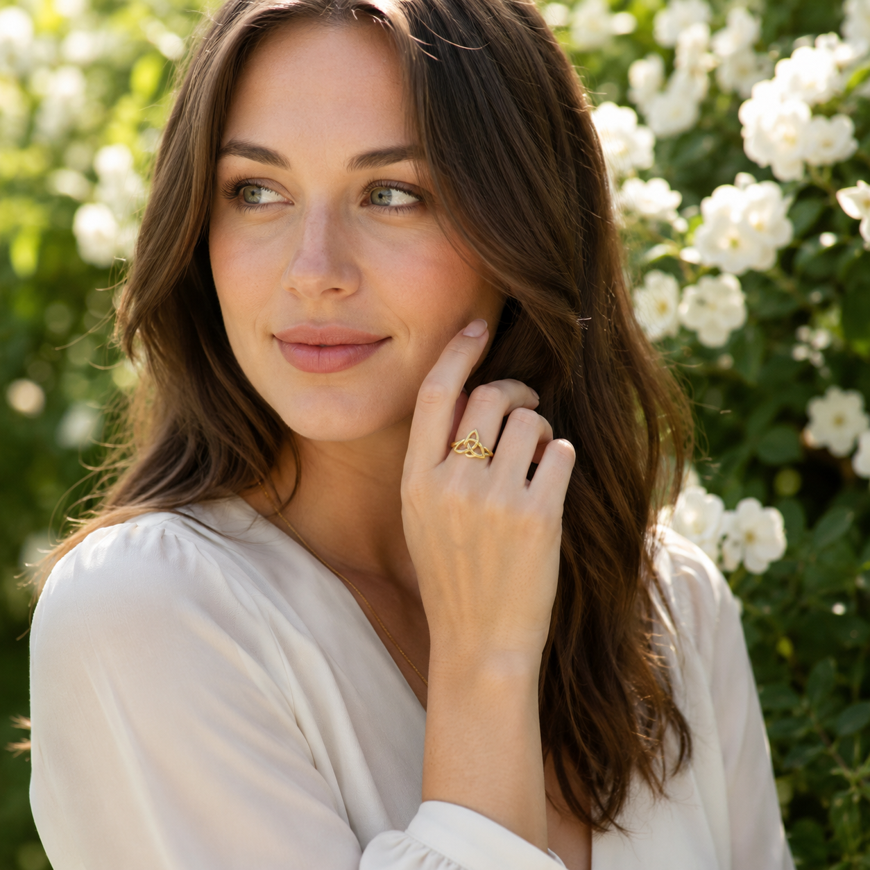 Woman styling the Witch's Knot Triquetra Ring with other jewelry